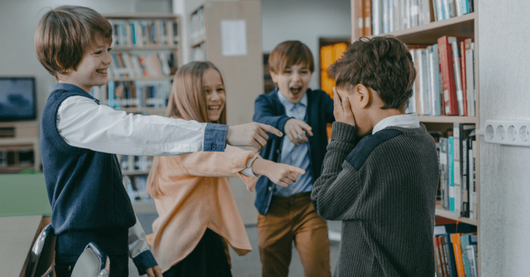 A child being bullied by three other students.