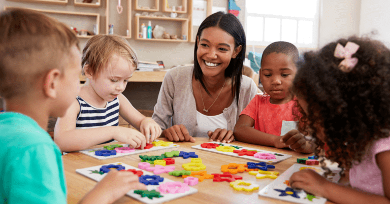 A teacher sitting with her students.